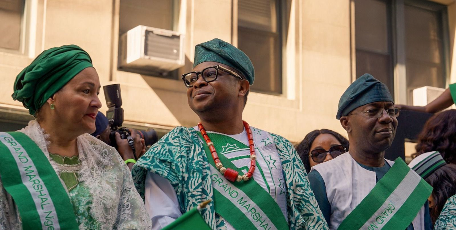 A guest waving a Nigerian flag in the street