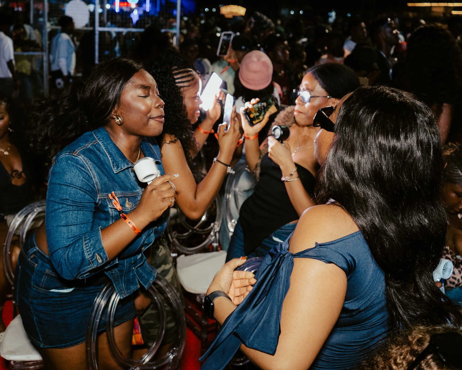 Friends filming and clapping at a Motherland event